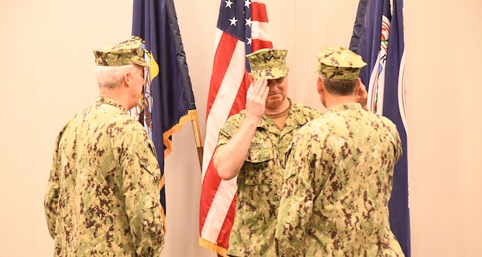 Admiral Christopher Grady, center, commander, United States Fleet Forces Command, presides over the Naval Warfare Development Command (NWDC) Change of Command July 3, 2019. Newly promoted Rear Admiral John F. Meier, left, assumed command from Rear Admiral Marcus Hitchcock, saluting. (U.S. Navy photo by AO1 Robert Martin, NWDC/Released)