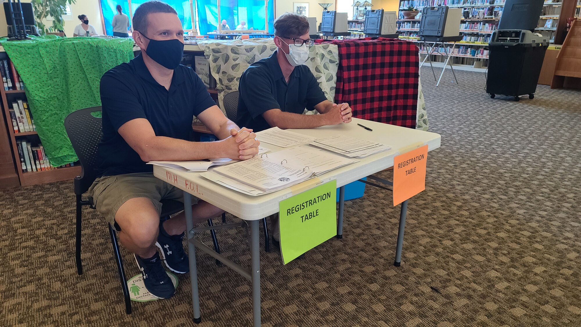U.S. Air Force Capt. Matthew Shaw, an environmental management officer with the 115th Fighter Wing, and Sgt. Corey Nolden, an infantryman assigned to the 1st Battalion, 128th Infantry staff a voter registration desk at the Mount Horeb Public Library during the Aug. 11 election in Mount Horeb, Wis. Nearly 700 Citizen Soldiers and Airmen from the Wisconsin National Guard mobilized to serve as poll workers across 40 Wisconsin counties. (U.S. Air National Guard photo by Senior Master Sgt. Larkin Wilde)