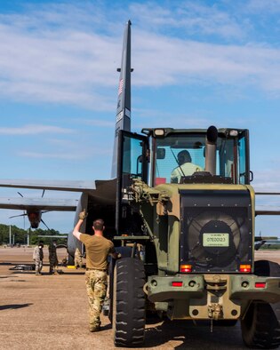 Reserve member of the 96th Aerial Port Squadron drives a forklift on the flightline to help load cargo pallets on a C-130J Super Hercules for training Aug. 2, 2020, at Little Rock Air Force Base, Ark. This was the first in-person training event for the 913th Airlift Group since COVID-19 swept across the U.S. Using health precaution measures, reserve members were able to restore readiness while mitigating health risks, ensuring no COVID-19 cases were transmitted among members over the weekend. The majority of our Reserve members have to meet the same requirements of Active Duty personnel. This means they have to balance a fulltime civilian job or college studies while maintaining their military readiness. (U.S. Air Force Reserve photo by Maj. Ashley Walker)