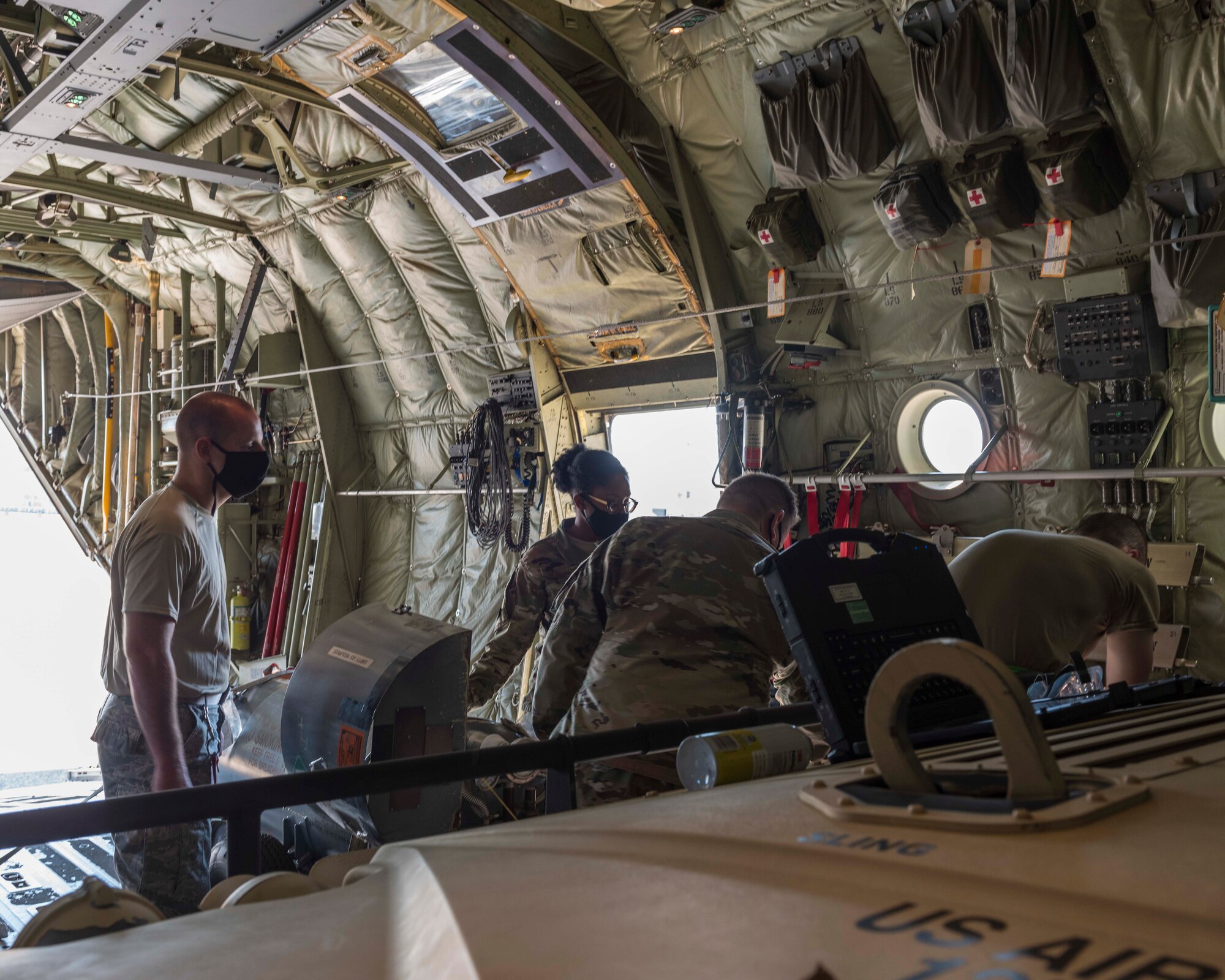 Reserve members of the 96th Aerial Port Squadron land 327th Airlift Squadron load a Humvee, liquid oxygen tanks, and cargo pallets on a C-130J Super Hercules for training Aug. 2, 2020, at Little Rock Air Force Base, Ark. This was the first in-person training event for the 913th Airlift Group since COVID-19 swept across the U.S. Using health precaution measures, reserve members were able to restore readiness while mitigating health risks, ensuring no COVID-19 cases were transmitted among members over the weekend. The majority of our Reserve members have to meet the same requirements of Active Duty personnel. This means they have to balance a full-time civilian job or college studies while maintaining their military readiness. (U.S. Air Force Reserve photo by Maj. Ashley Walker)