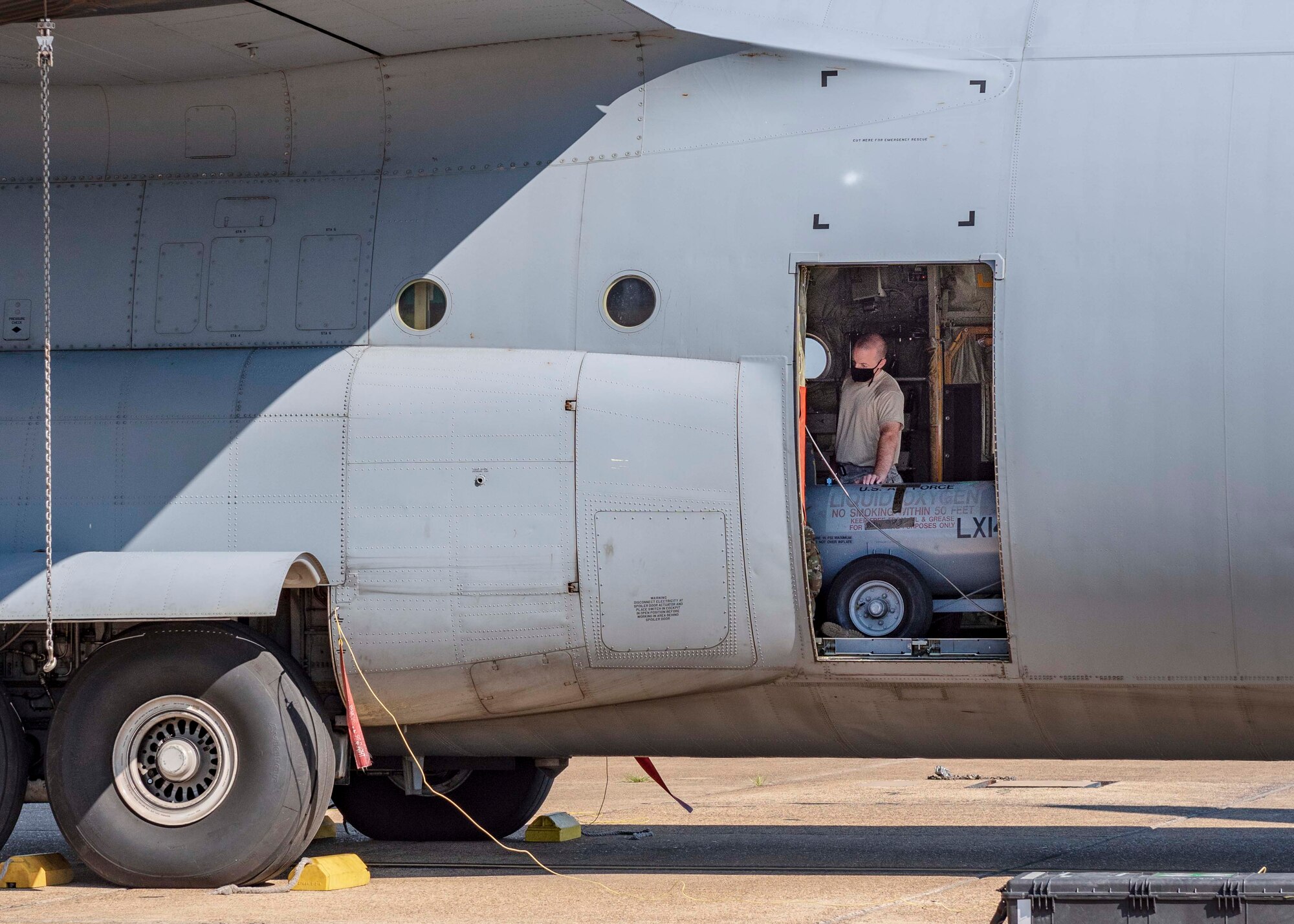 Reserve members of the 96th Aerial Port Squadron load a Humvee, liquid oxygen tanks, and cargo pallets on a C-130J Super Hercules for training Aug. 2, 2020, at Little Rock Air Force Base, Ark. This was the first in-person training event for the 913th Airlift Group since COVID-19 swept across the U.S. Using health precaution measures, reserve members were able to restore readiness while mitigating health risks, ensuring no COVID-19 cases were transmitted among members over the weekend. The majority of our Reserve members have to meet the same requirements of Active Duty personnel. This means they have to balance a fulltime civilian job or college studies while maintaining their military readiness. (U.S. Air Force Reserve photo by Maj. Ashley Walker)