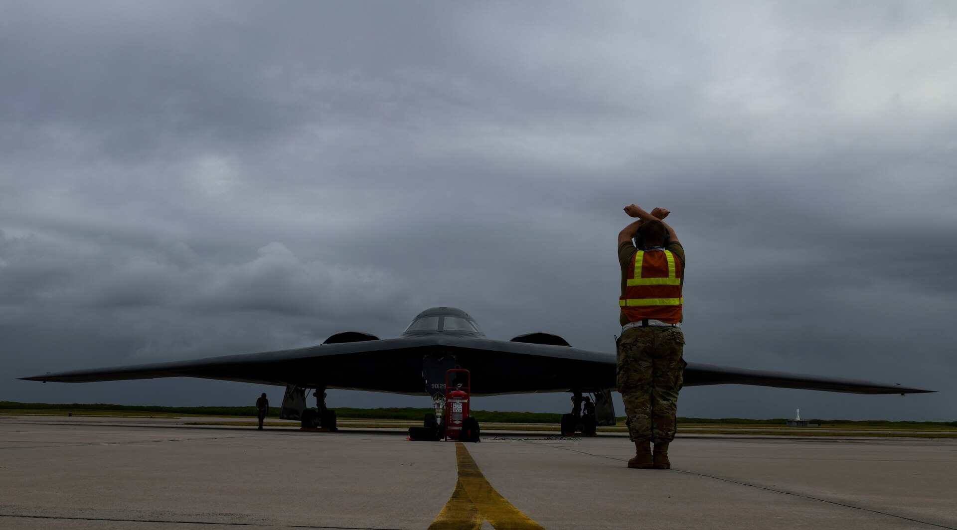 Staff Sgt. Mark Farrar, 131st Aircraft Maintenance Squadron crew chief stationed at Whiteman Air Force Base, Missouri, marshalls a B-2 Spirit Stealth Bomber as it arrives at Naval Support Facility Diego Garcia, Aug. 12, 2020. Three B-2 Spirits from Whiteman AFB deployed to NSF Diego Garcia to support U.S. security commitments in the Indo-Pacific region. (U.S. Air Force photo by Tech. Sgt. Heather Salazar)