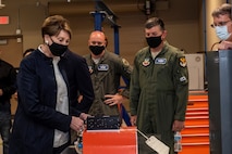 Barbara M. Barrett looks at aircraft equipment.