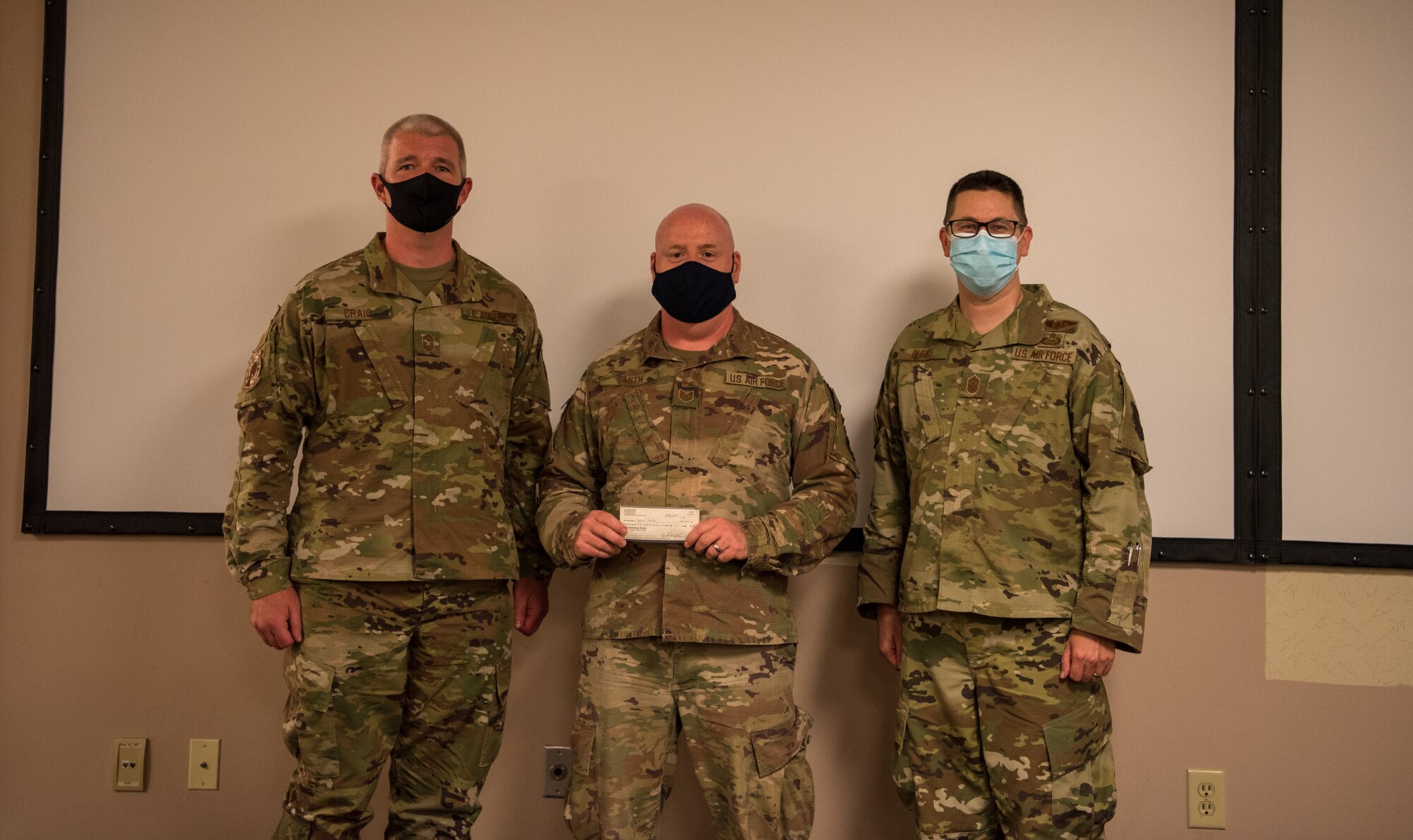 Tech. Sgt. Steven Smith of the 315th Security Forces Squadron at JB Charleston, recieves $5,000 SMSgt George Counts Scholarship from the 315th Airlift Wing Top 3 leadership, Senior Master Sgt. Michael Craig and Chief Master Sgt. John-Paul Burke. The scholarship was created in 2018, to honor the late 315th AW wingman by assiting Airmen in higher education.
