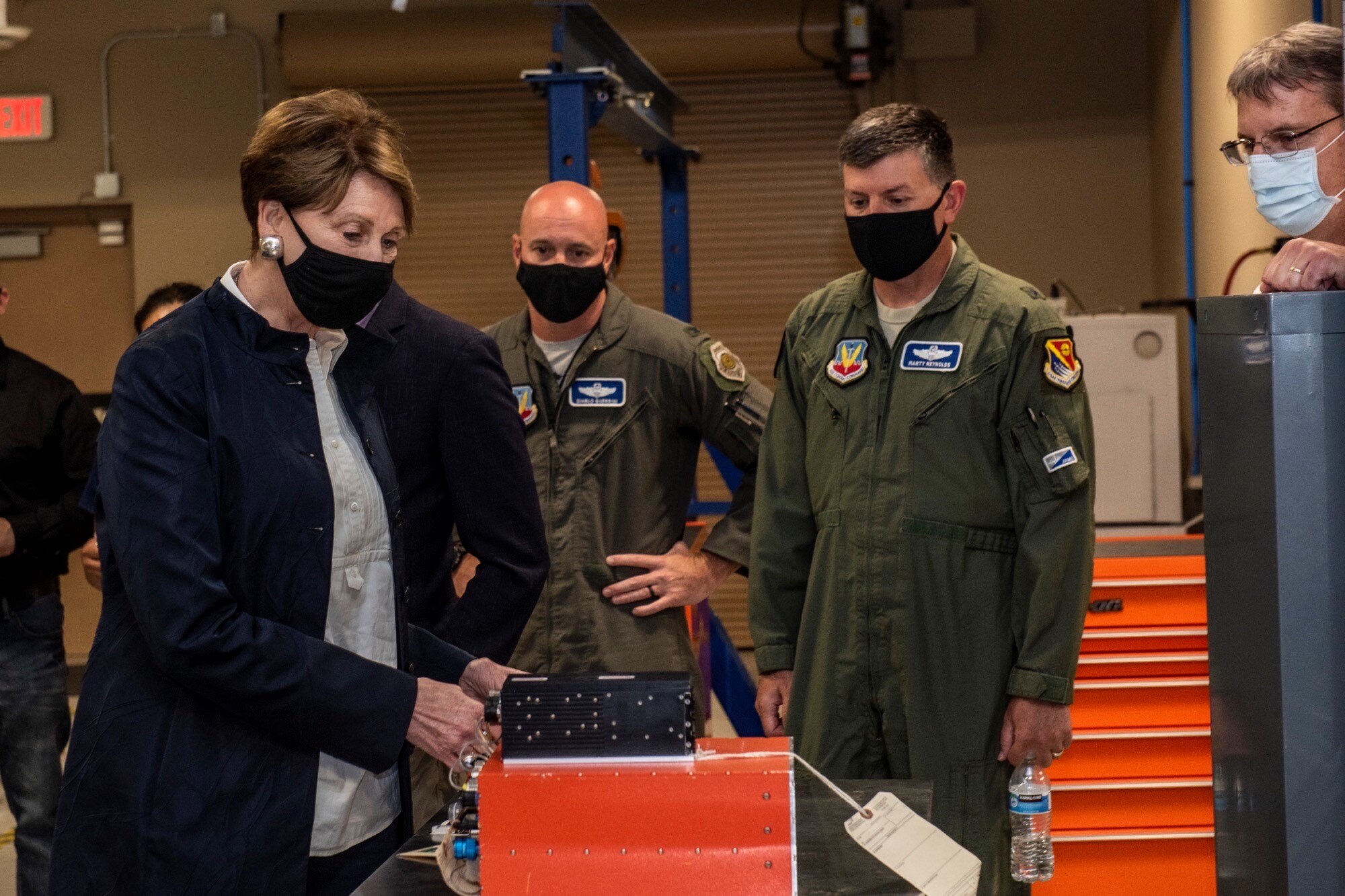 Barbara M. Barrett looks at aircraft equipment.