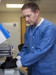 Army Capt. Eric Coate, Molecular Diagnostics officer in charge, loads patient samples for COVID-19 ribonucleic acid (RNA) testing at Brooke Army Medical Center, Joint Base San Antonio-Fort Sam Houston, April 9.