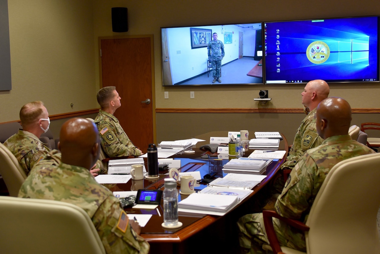 A soldier addresses a panel.