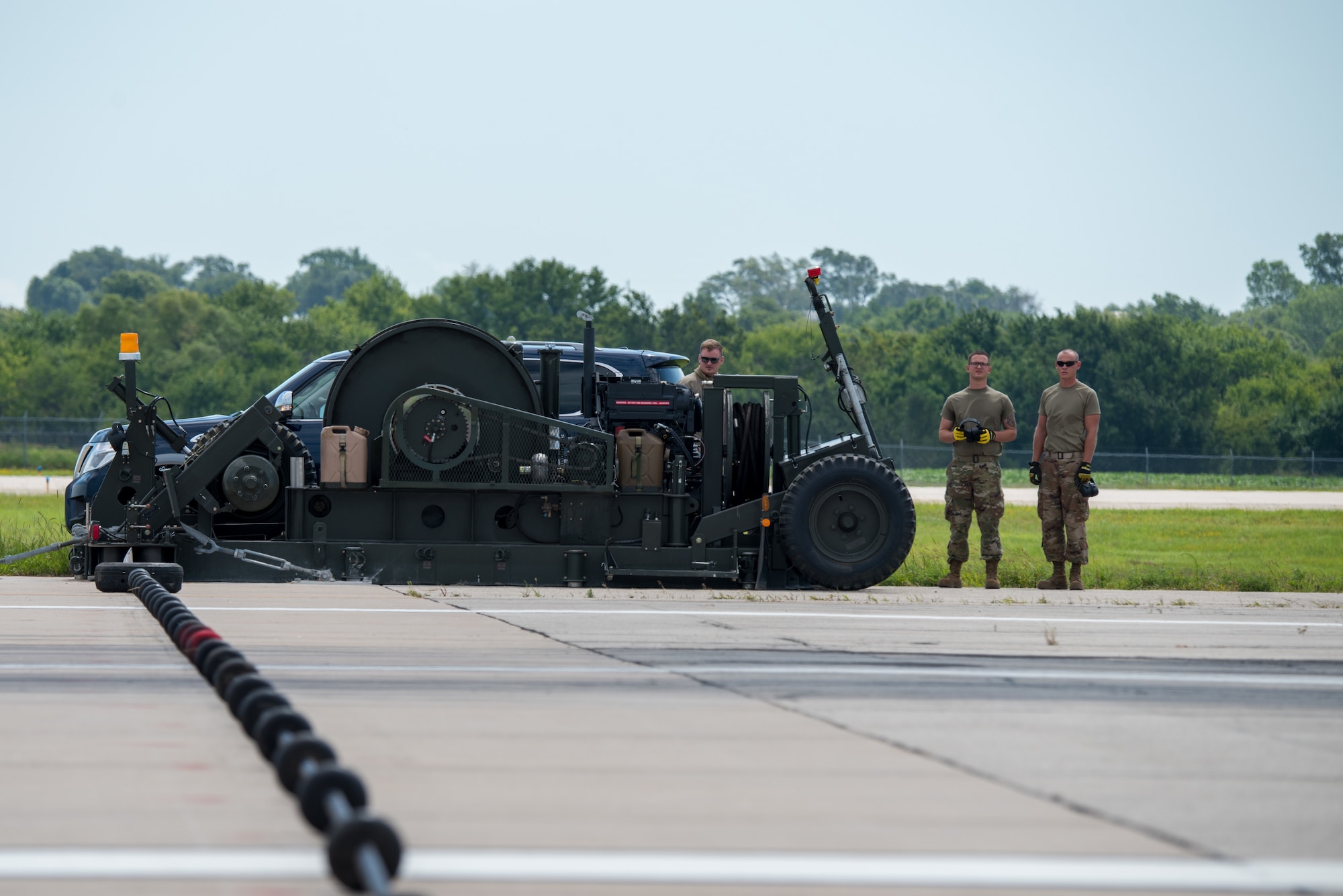 A mobile aircraft arresting system is prepared to be tested by two 77th Fighter Squadron F-16 Fighting Falcons from Shaw Air Force Base, South Carolina, Aug. 6, 2020, at McConnell Air Force Base, Kansas. The MAAS prevents tail-hooked enabled aircraft from overrunning the runway during takeoff and landing emergencies. (U.S. Air Force photo by Airman 1st Class Marc A. Garcia)