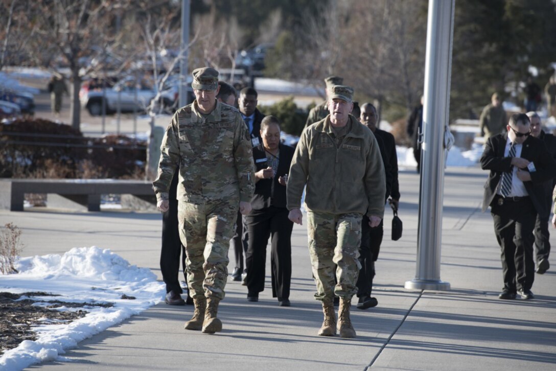 Two Air Force generals walk to a building for a briefing.