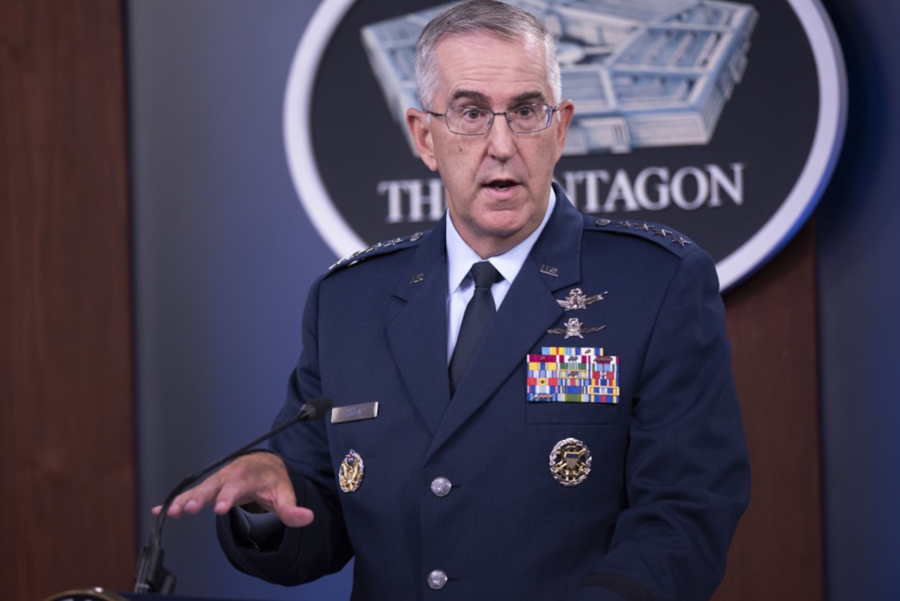 Air Force general gestures while briefing reporters.