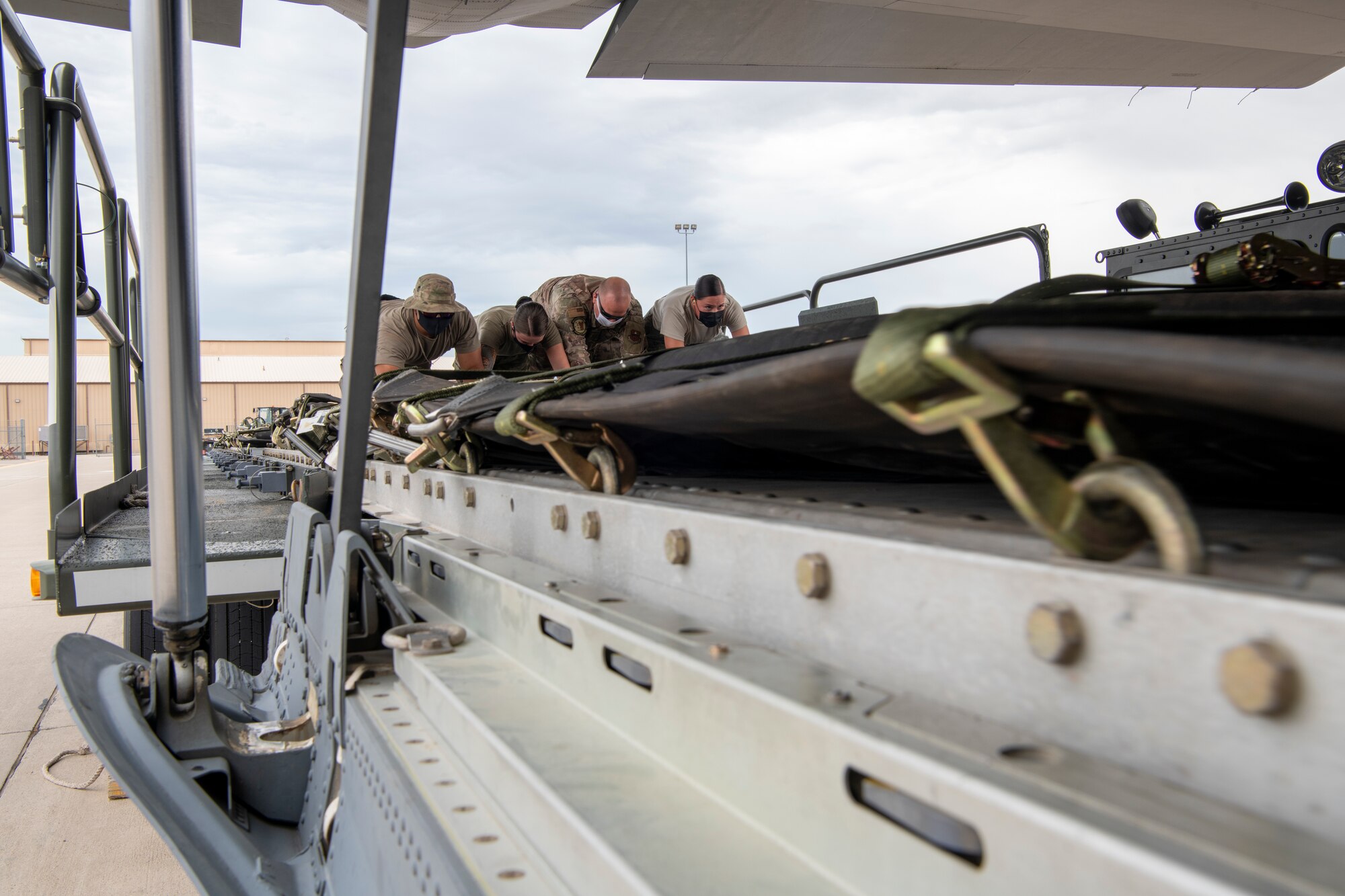 Airmen push a fuel pump onto a plane