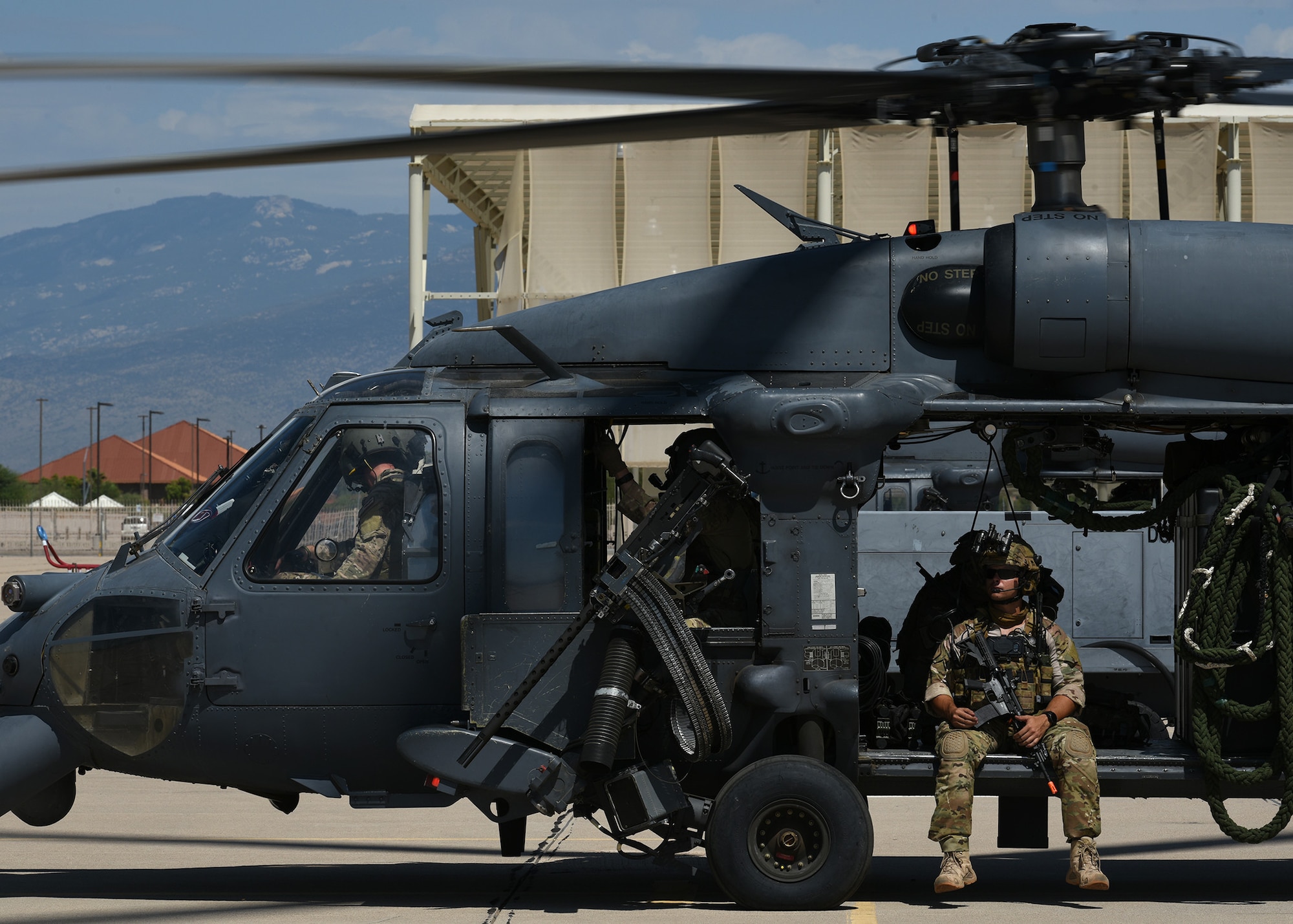 Photo Air Force Airmen in an HH-60G Pavehawk on a military flightline