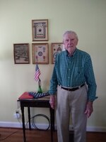 Man stands in front of patches and medals.