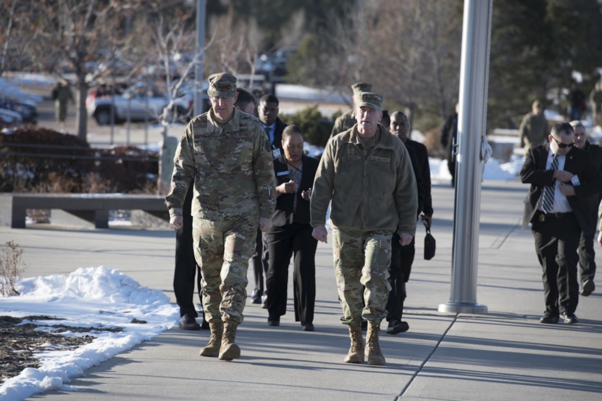 Two Air Force generals walk to a building for a briefing.