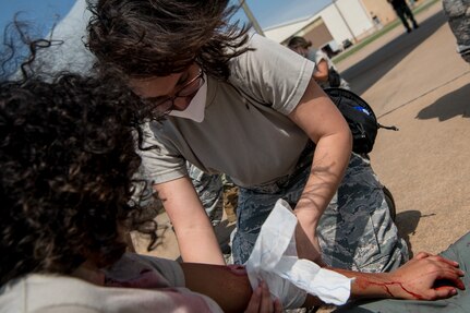 aerospace medical technician treats simulated wounded patient