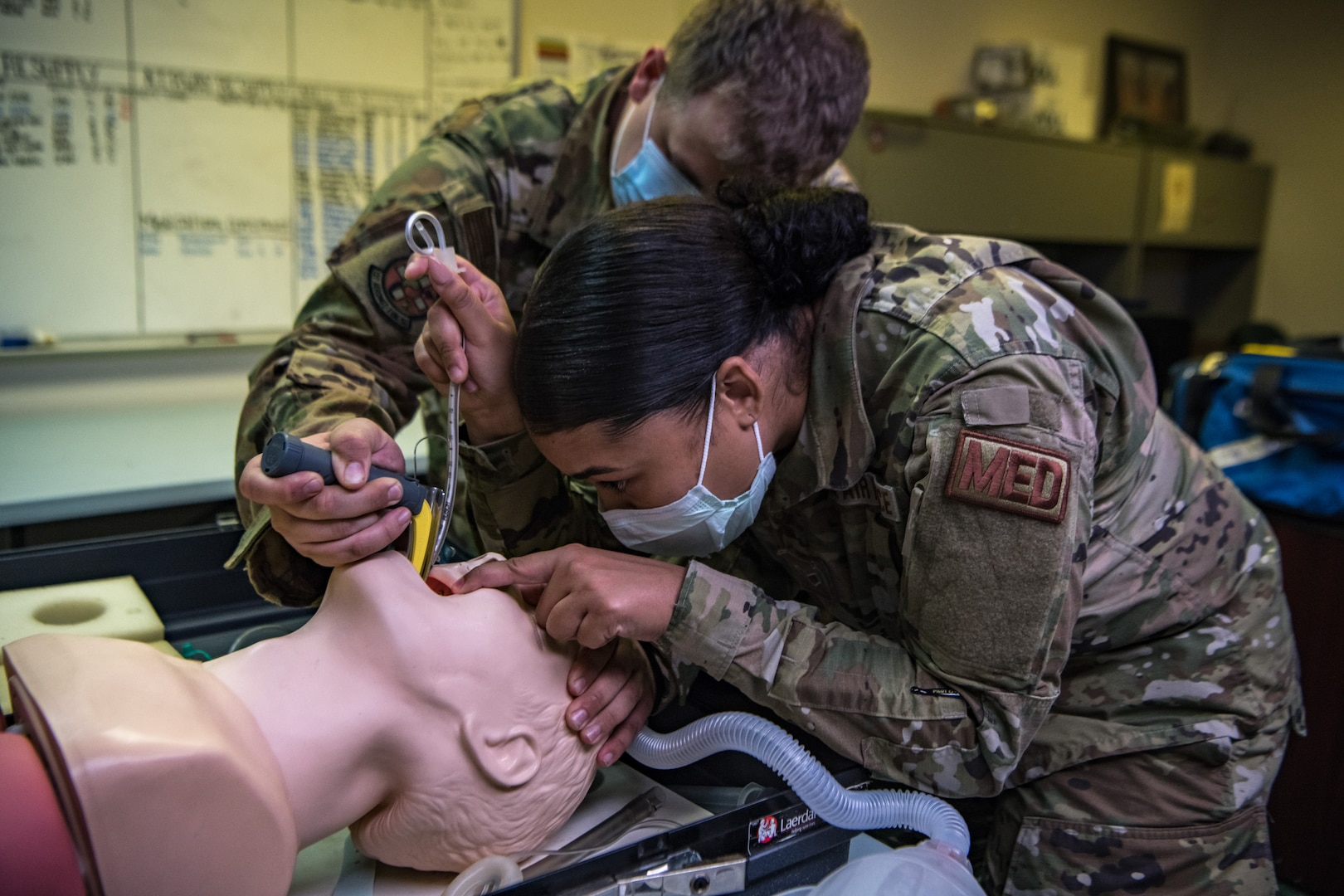 aerospace medical technicians intubates a training mannequin
