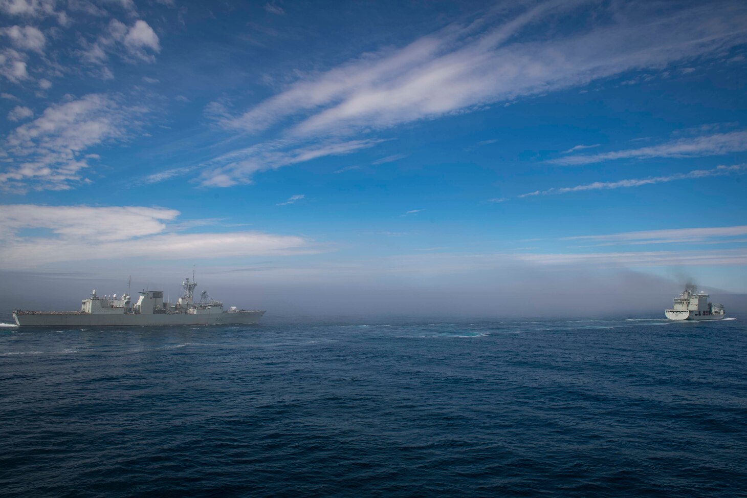 The Royal Canadian Navy ship HMCS Ville de Quebec (FFH 332), left, and  USS Thomas Hudner (DDG 116)