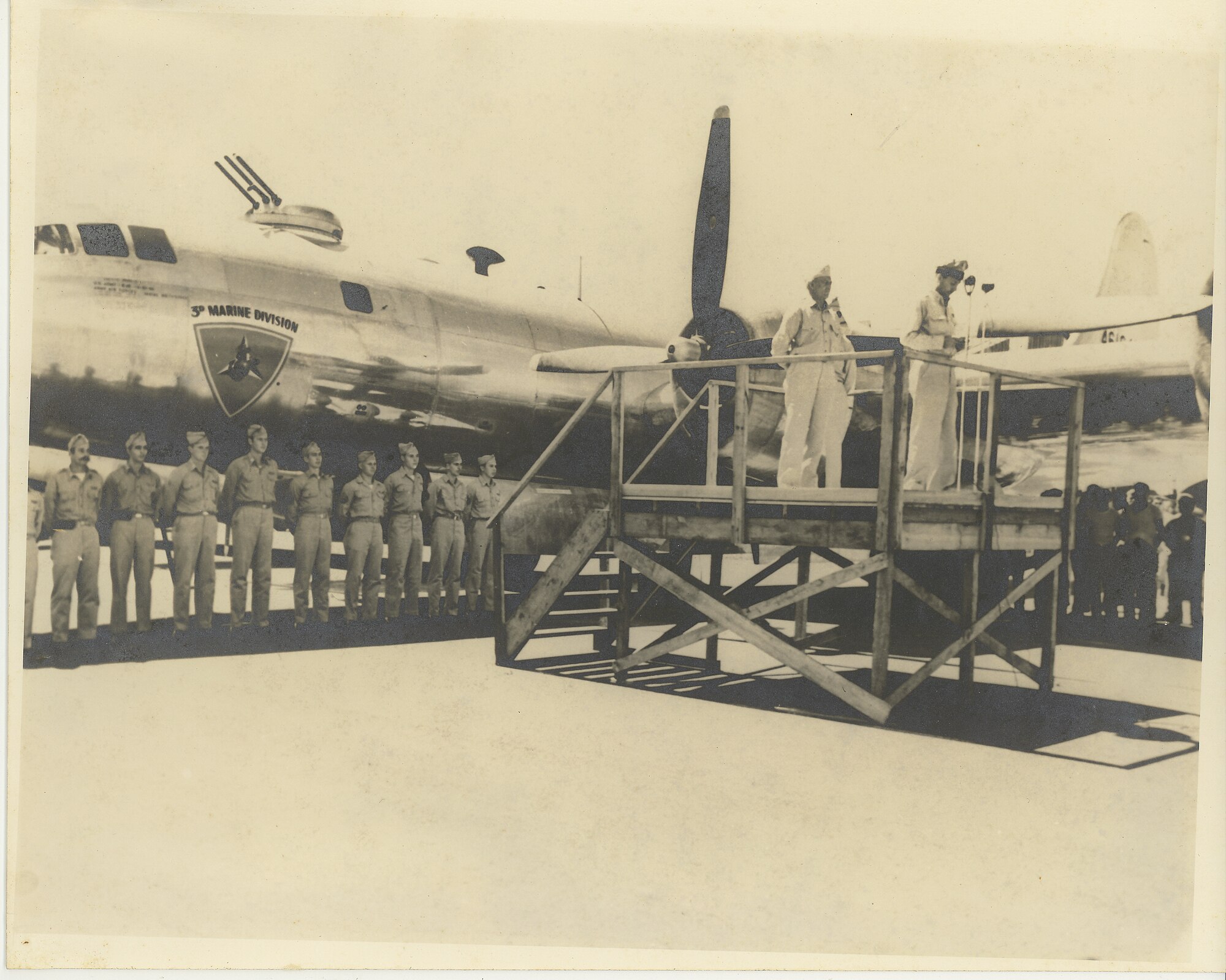 Men stand in front of a B-29 bomber.