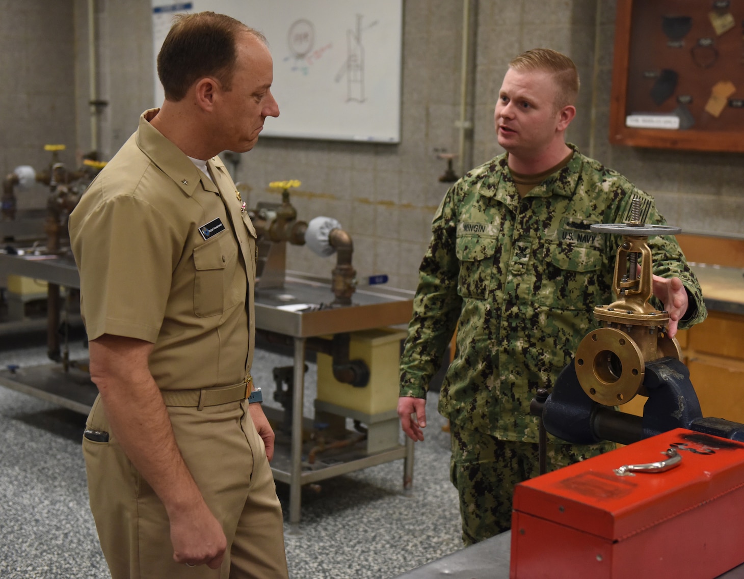 Turbine Systems Technician (Mechanical) 1st Class Steve Mingin an instructor at Surface Warfare Engineering School Command; Great Lakes explains the valve lab that is part of the Basic Engineering Common Core course that enlisted engineer sailors go through to Rear Admiral Robert C. Nowakowski; Deputy Commander; Navy Recruiting Command and Deputy Commander; Naval Education and Training Command.