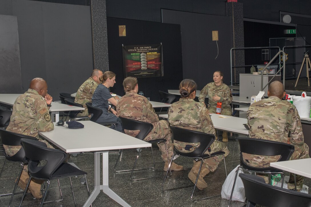 A group of military service members sitting at a meeting.