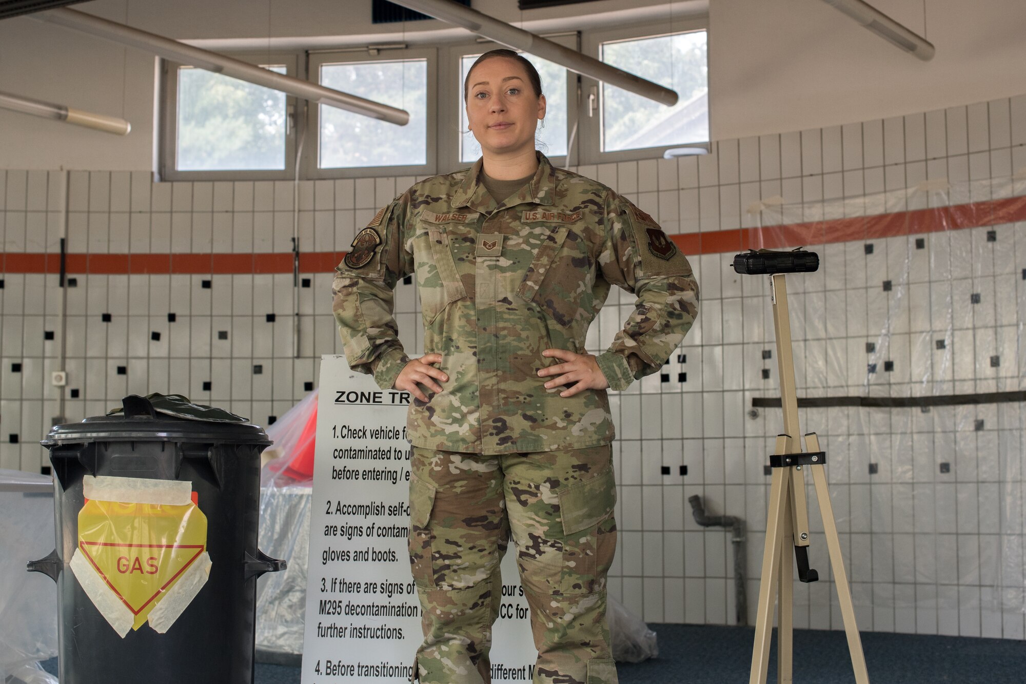 An Airman standing in front of emergency management training material.