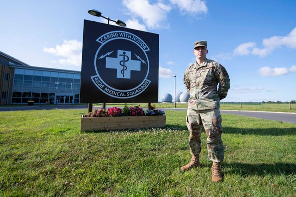 U.S. Air Force Tech. Sgt. Steve Zavala, 422nd Medical Squadron medical operations flight chief and trusted care champion, poses for a photo in front of the 422nd MDS building at RAF Croughton, England, August 3, 2020. Zavala discovered a COVID-19 testing technique that needed to be changed, so he elevated the concern and impacted testing procedures across the Department of Defense. (U.S. Air Force photo by Airman 1st Class Jennifer Zima).