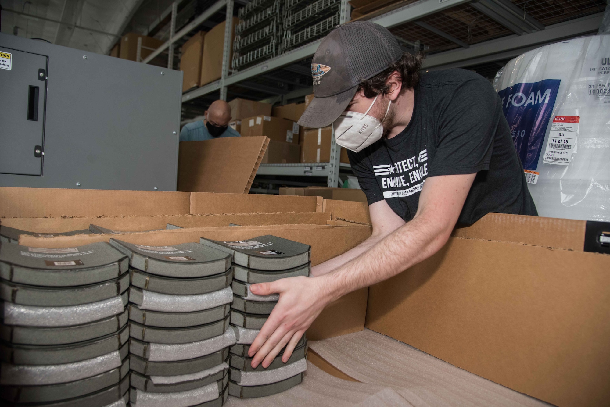 Dominic Dugo II, Survice Engineering Company non-destructive testing equipment technician, packages body armor plates Aug. 6, 2020, at McConnell Air Force Base, Kansas. McConnell AFB was selected as the hub to serve six regional installations to inspect all body armor plates. Once the plates are approved and packaged, they are returned to their respective units. (U.S. Air Force photo by Airman 1st Class Marc A. Garcia)