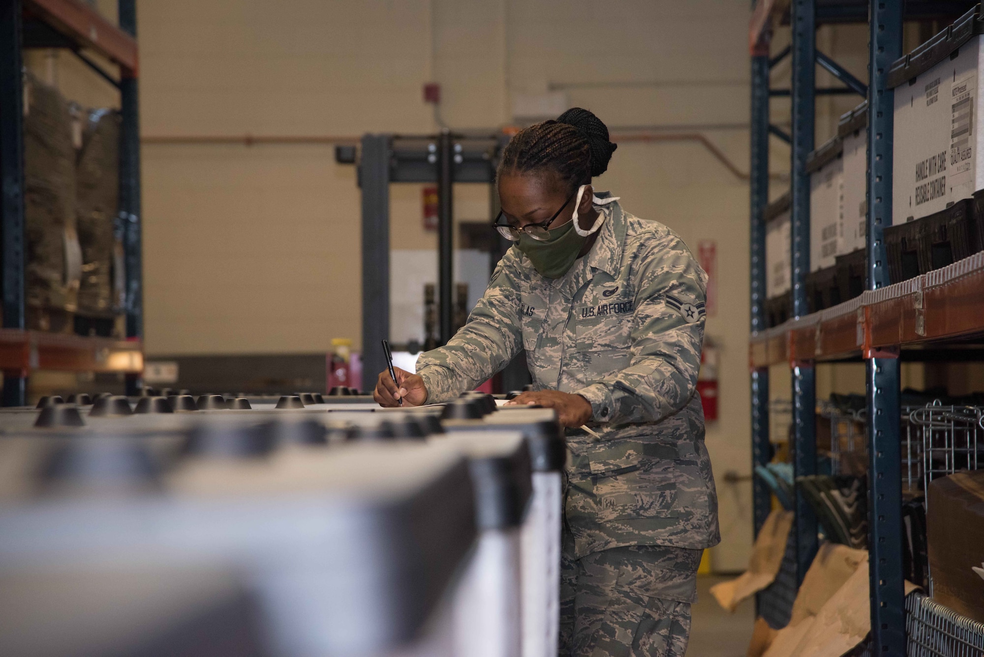 Airman 1st Class Mikah Douglas, 22nd Logistics Readiness Squadron individual protective equipment technician, reviews a packing list for inspected body armor plates returning to Tinker Air Force Base, Oklahoma, Aug. 6, 2020, at McConnell Air Force Base, Kansas. McConnell AFB has been selected to serve as a regional hub for six surrounding installations to provide quality control measures deploying the equipment to combat zones overseas operations overseas. (U.S. Air Force photo by Airman 1st Class Marc A. Garcia)