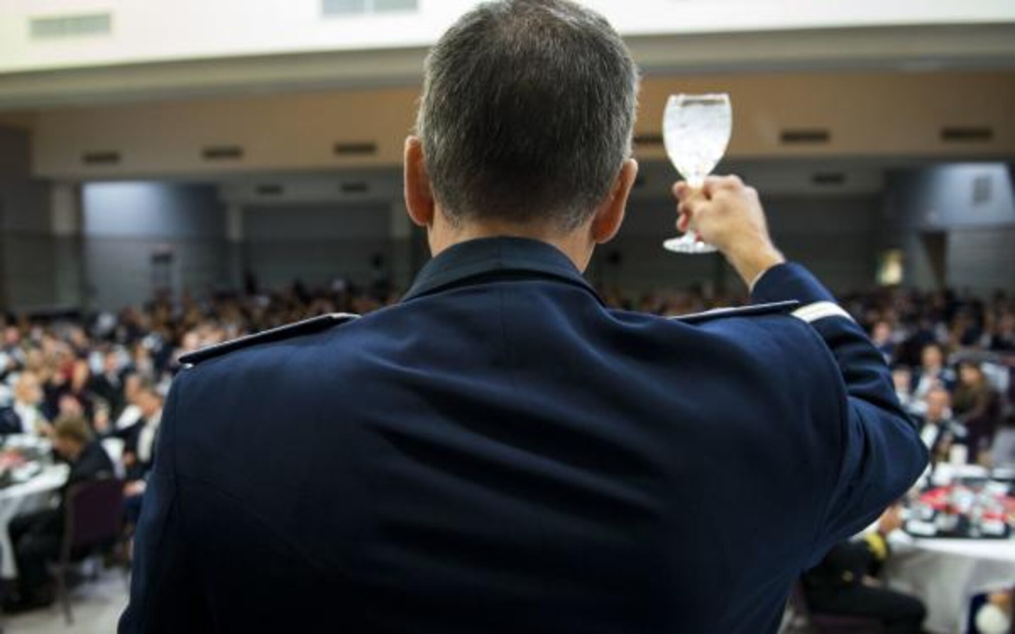 Photo of Airman giving a ceremonial toast