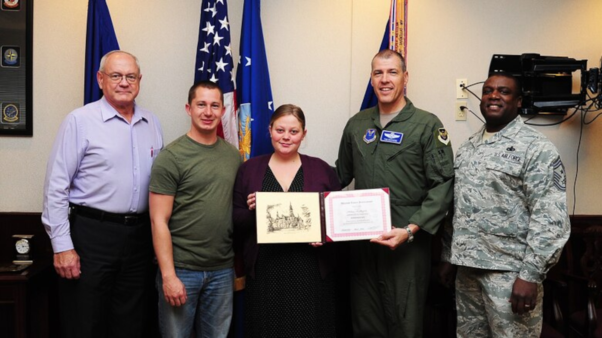 Michelle Slayton, center, a Park University student, accepts the Military Family Scholarship from Brig. Gen. Thomas A. Bussiere, 509th Bomb Wing commander, and Chief Master Sgt. Lee Barr, 509th BW command chief, Nov. 13, 2013, at Whiteman Air Force Base, Mo. Also pictured are Dale Buckingham, Park University campus center director and Michelle’s husband, Christopher, from the 509th Maintenance Squadron. (U.S. Air Force photo by Staff Sgt. Brigitte N. Brantley/Released)