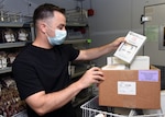 Sgt. Stephen Freed from the U.S. Army Institute of Surgical Research inspects a batch of COVID-19 convalescent plasma ready to be shipped from the South Texas Blood & Tissue Center.