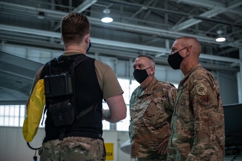 An Airman talks to his commander and his chief about his experience with the personal cooling system.