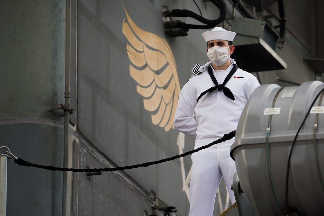 A sailor stands on a flight deck.
