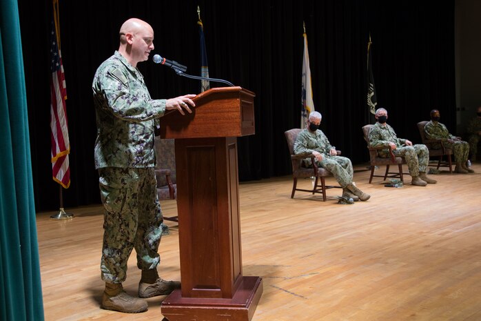 Capt. Peter Mirisola, left, delivers remarks as the outgoing commander of Destroyer Squadron (DESRON) 50 and Commander, Task force (CTF) 55 during a change of command ceremony presided over by Vice Adm. Jim Malloy, center, commander U.S. Naval Forces Central Command, U.S. 5th Fleet and Combined Maritime Forces, onboard Naval Support Activity Bahrain. DESRON 50 and CTF 55 operate in the U.S. 5th Fleet area of operations in support of naval operations to ensure maritime stability and security in the Central Region, connecting the Mediterranean and Pacific through the Western Indian Ocean and three critical chokepoints to the free flow of global commerce.