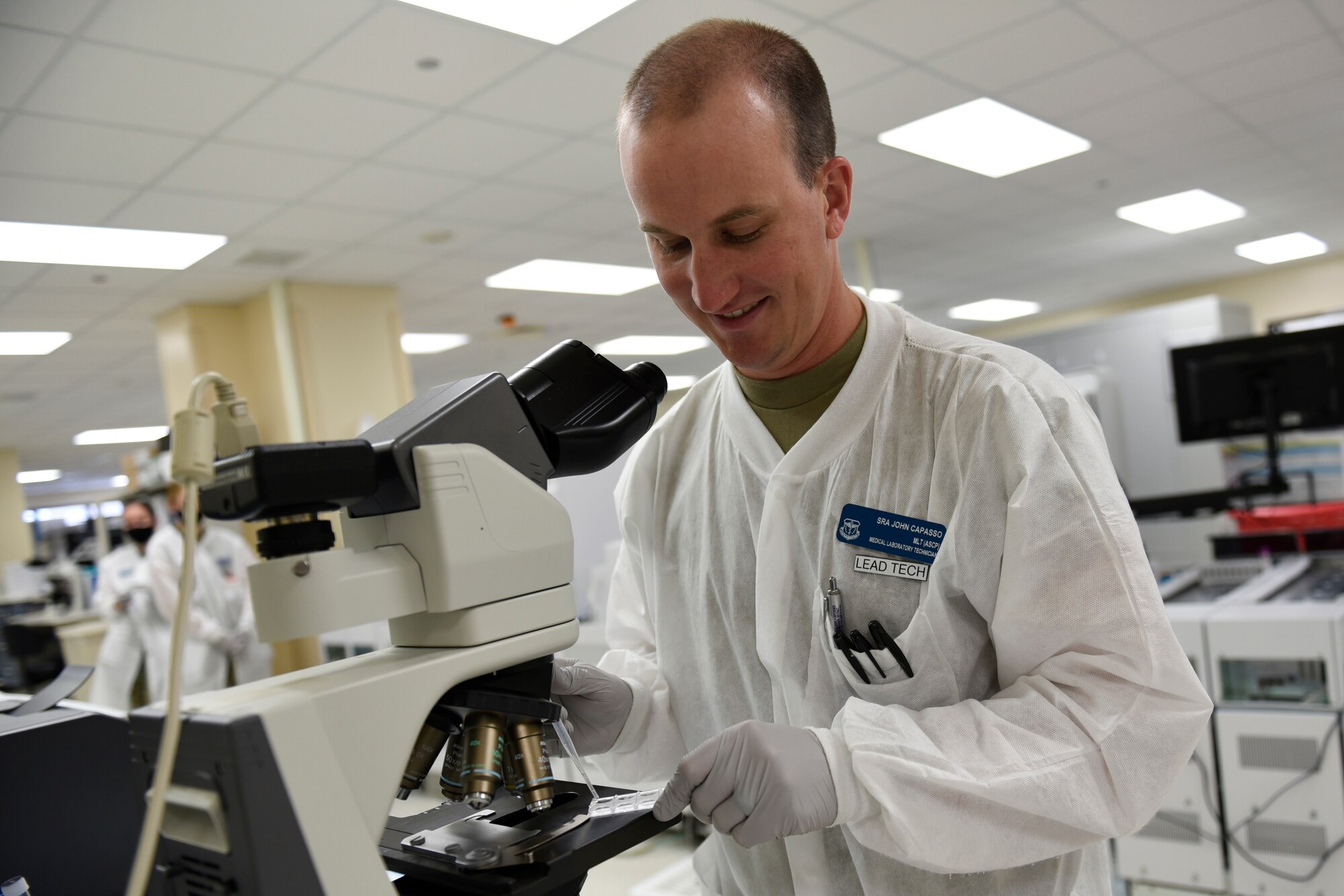 U.S. Air Force Senior Airman John Capasso, 60th Medical Diagnostics and Therapeutics Squadron medical laboratory technician, places a urine sample under a microscope for analysis Aug. 11, 2020, at Travis Air Force Base, California. Capasso was the Warrior of the Week from Aug. 9-15, 2020. The program recognizes outstanding Airmen who have made significant contributions to their unit. (U.S. Air Force photo by Airman 1st Class Cameron Otte)