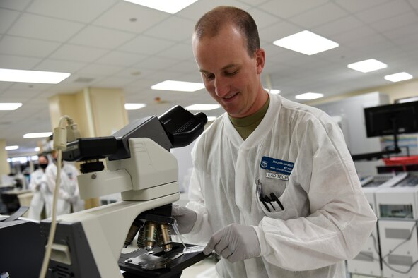 U.S. Air Force Senior Airman John Capasso, 60th Medical Diagnostics and Therapeutics Squadron medical laboratory technician, places a urine sample under a microscope for analysis Aug. 11, 2020, at Travis Air Force Base, California. Capasso was the Warrior of the Week from Aug. 9-15, 2020. The program recognizes outstanding Airmen who have made significant contributions to their unit. (U.S. Air Force photo by Airman 1st Class Cameron Otte)