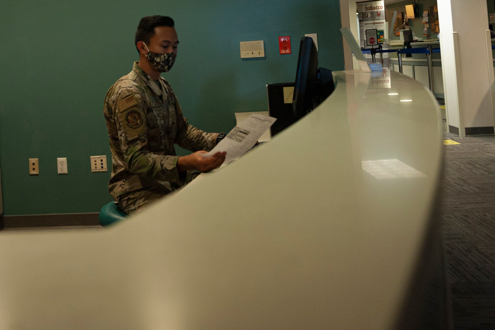 Photo of an Airman reading a paper prescription