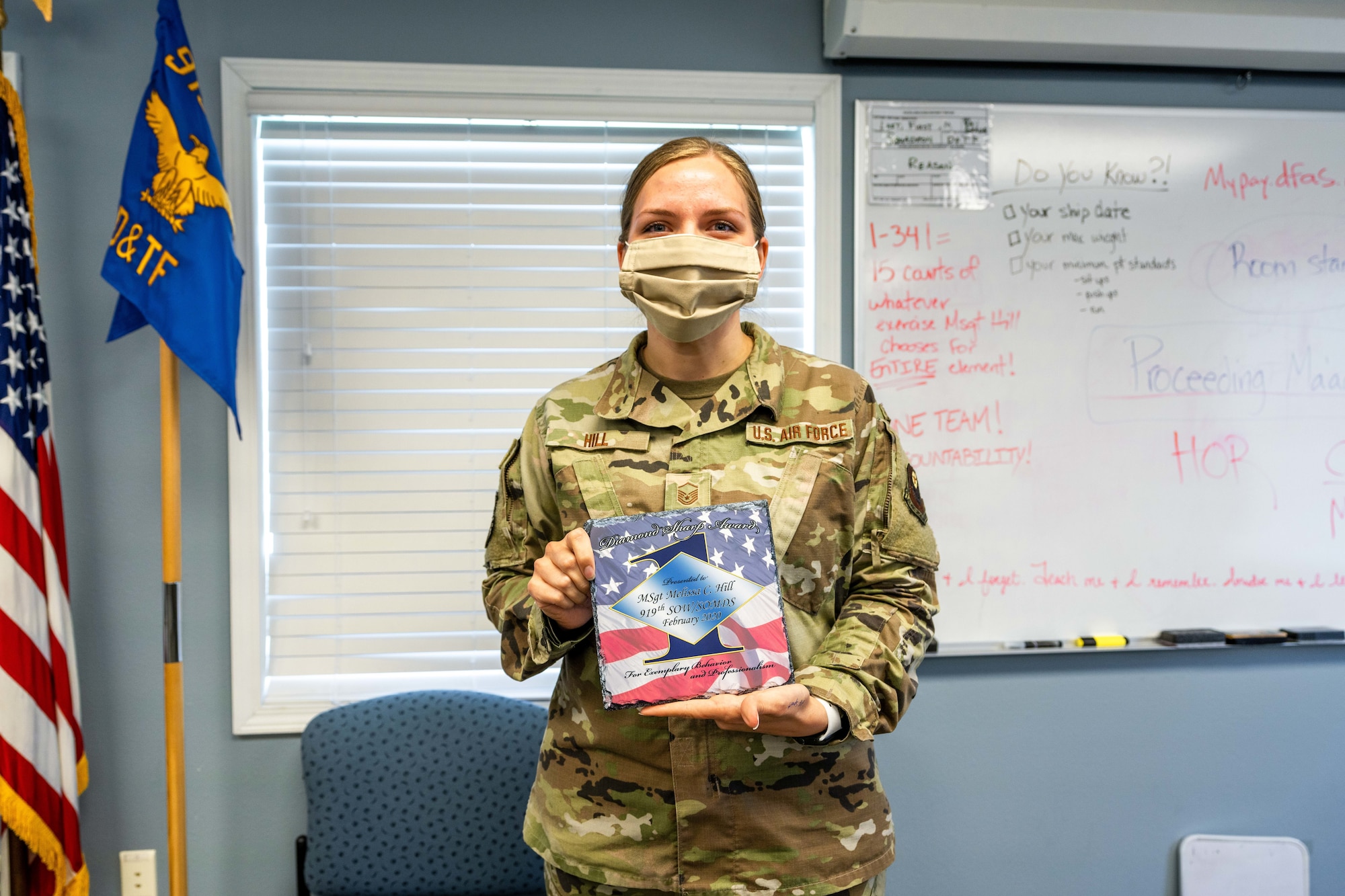 Airman stands with award