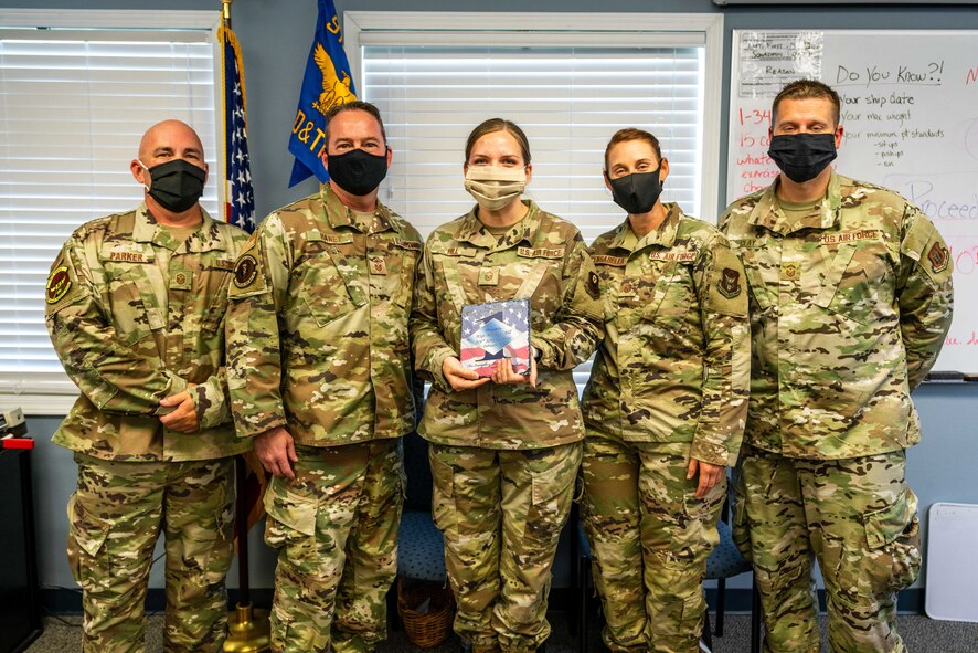 Photo of five Airmen standing in a group