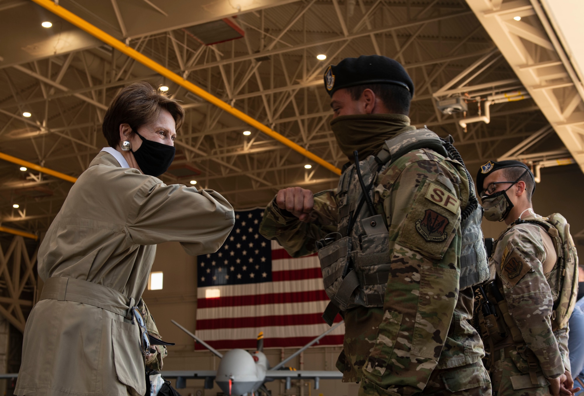 Secretary of the Air Force Barbara Barrett greets a Creech Air Force Base Defender.