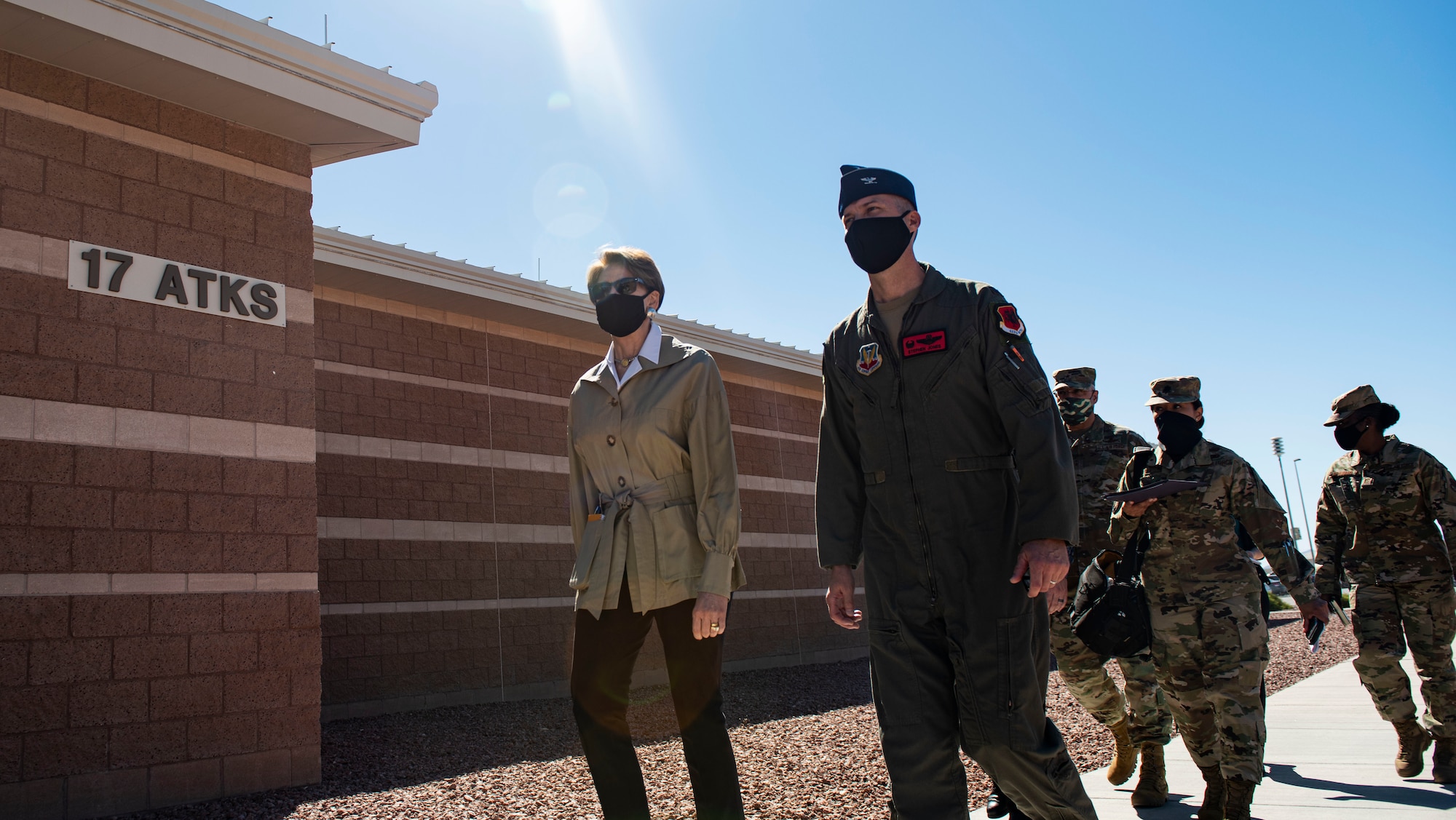 Secretary of the Air Force Barbara Barrett and Creech leadership walk into a building.