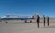 Leadership from Creech Air Force Base salute the aircraft carrying Secretary of the AF Barrett on the flight line.