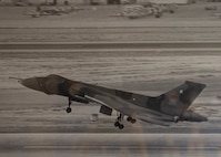 An aircraft lands at Nellis Air Force Base.