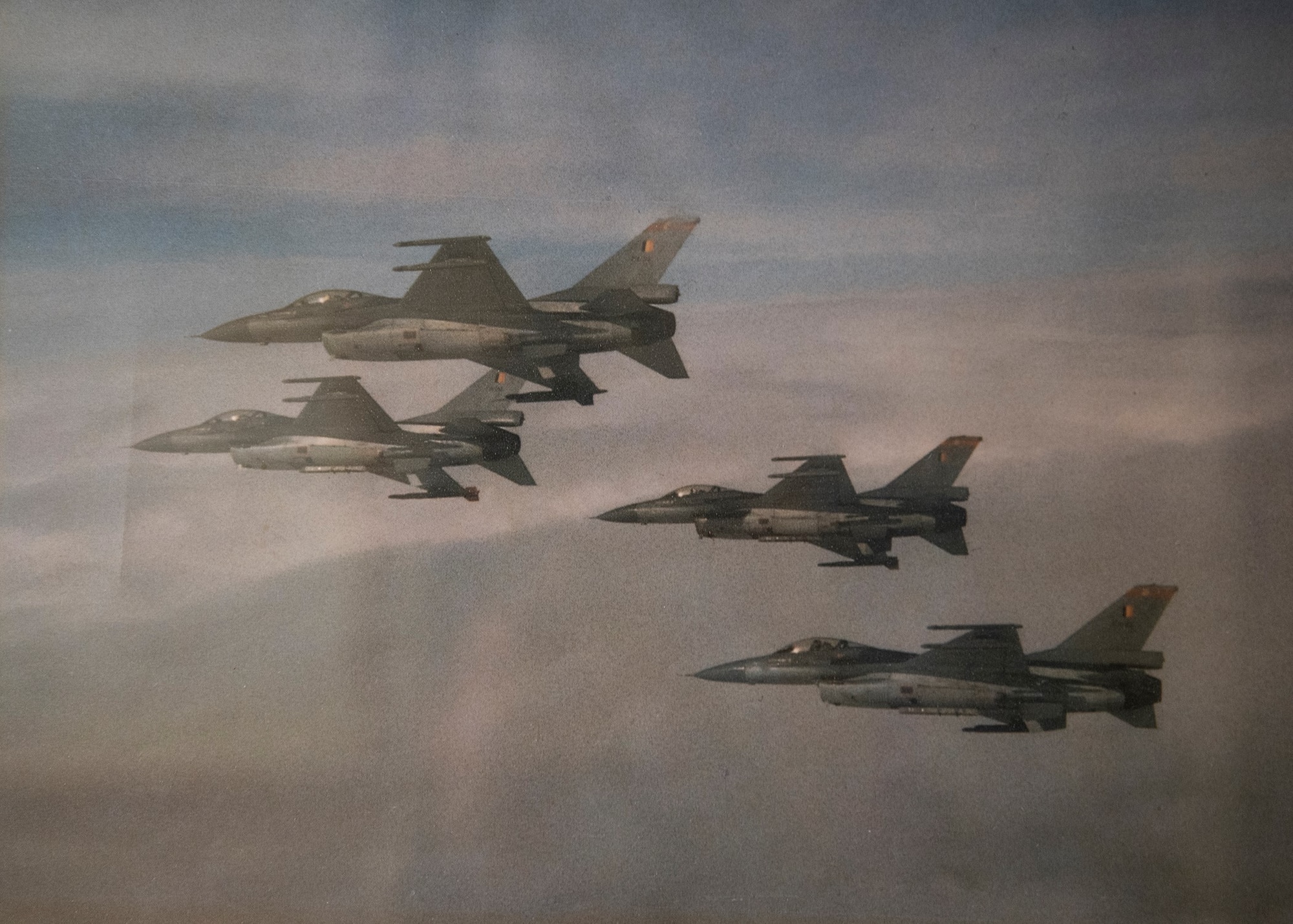 Four Belgian F-16s fly in formation.