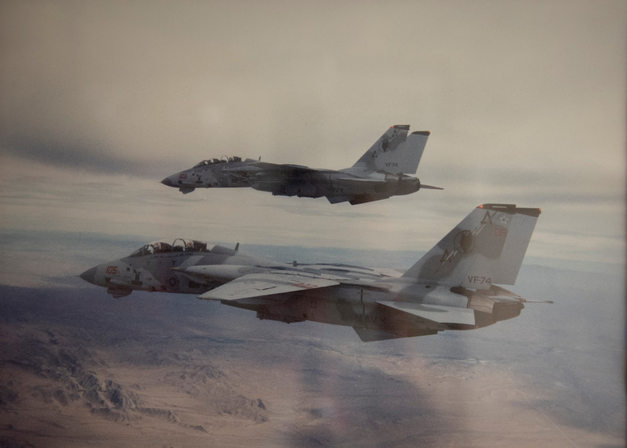 Two F-14s fly in formation.