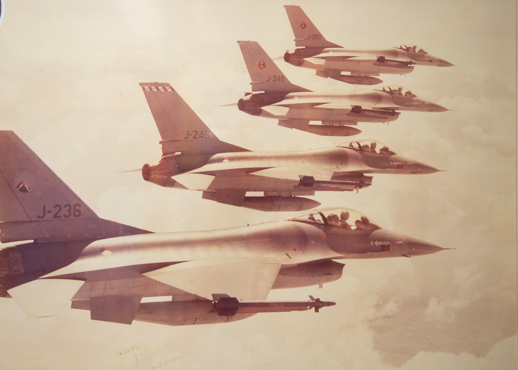Four F-16s fly in formation.