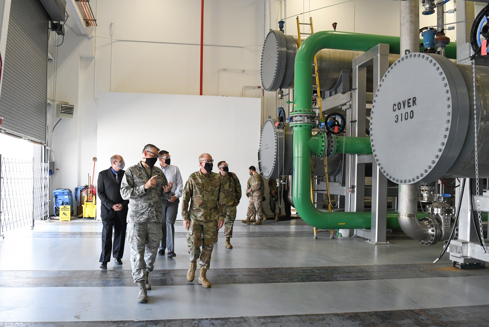 Lt. Col. Adam Quick, front left, director of the Arnold Engineering Development Complex (AEDC) Space and Missile Branch, briefs Vice Chief of Staff of the Air Force Gen. Stephen Wilson as they walk through part of the arc heater facility Aug. 11, 2020, at Arnold Air Force Base, Tenn. Arc heaters allow for the testing of thermal protection systems in simulated environments representative of hypersonic flight. (U.S. Air Force photo by Jill Pickett)