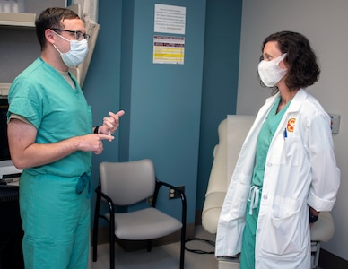 U.S. Air Force Col. (Dr.) Heather Yun, Brooke Army Medical Center Deputy Commander for Medical Services, talks with U.S. Air Force Capt. Joseph Marcus, senior infectious disease fellow, about COVID-19 research at Brooke Army Medical Center at Joint Base San Antonio-Fort Sam Houston Aug. 11. Yun acts as a mentor to BAMC’s ID fellows. The ID fellowship program trains up to 12 ID physicians per year.