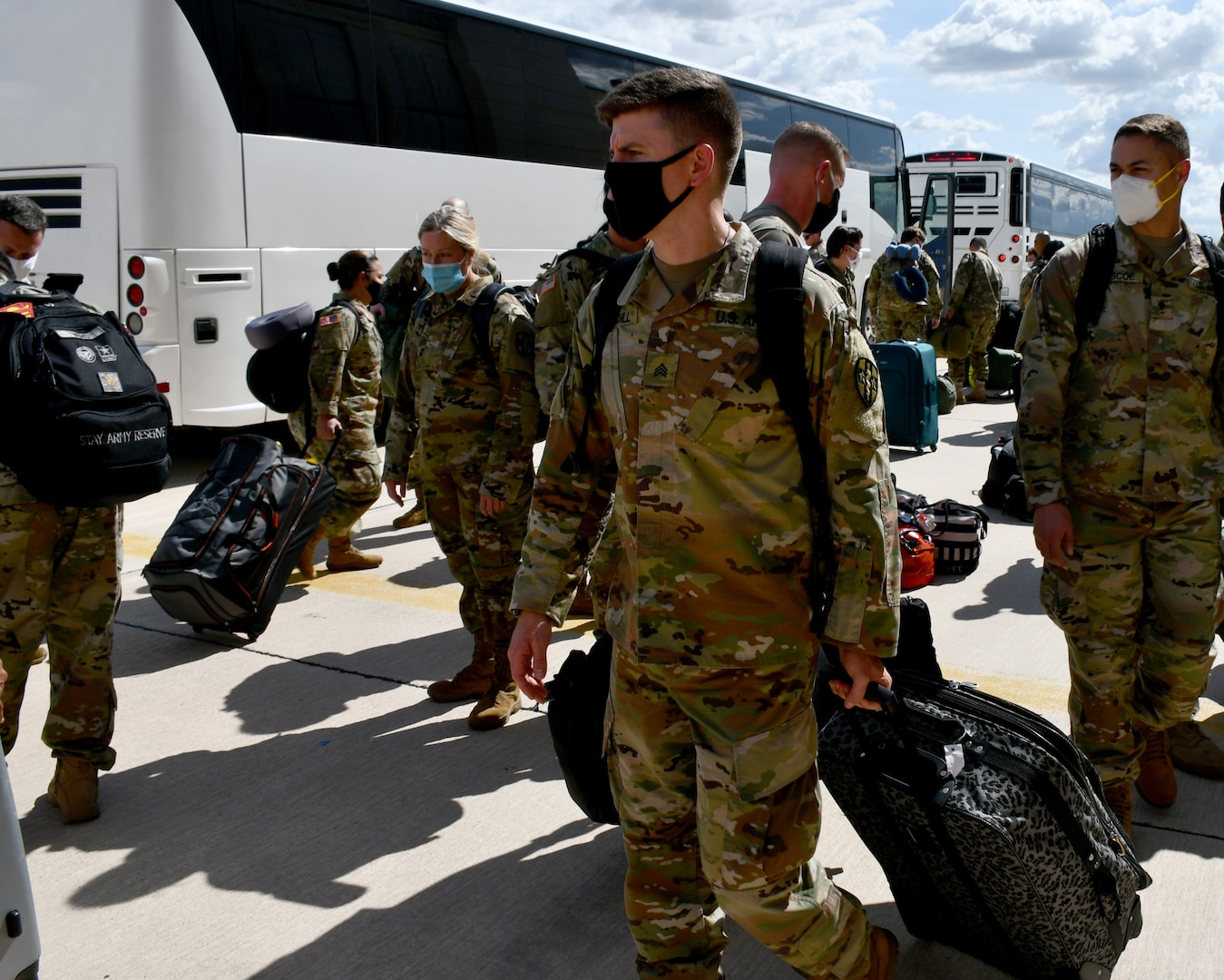 Soldiers getting off a bus.