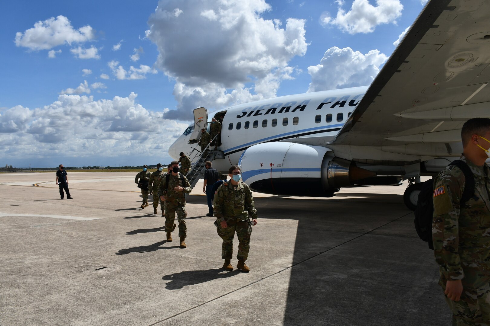 Soldier getting off airplane.